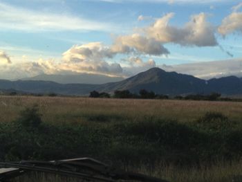 Scenic view of landscape against cloudy sky