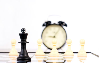 Close-up of chess pieces against white background