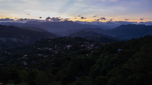 Scenic view of mountains against sky at sunset