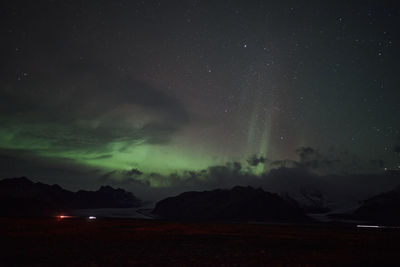 Scenic view of mountains against sky at night