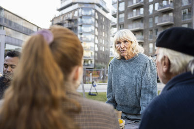 Neighbors meeting in courtyard