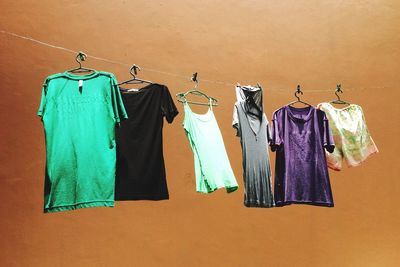 Low angle view of clothes drying on clothesline against wall