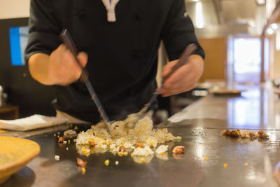 Midsection of man working at food