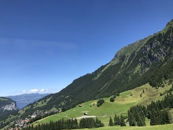 Scenic view of landscape against blue sky