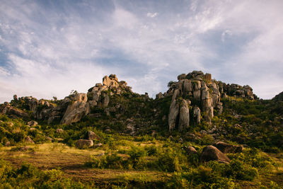 Rock formations on landscape against sky