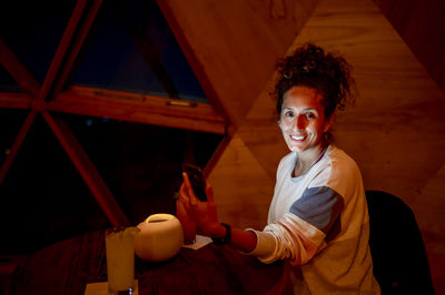 Relaxed woman inside a dome tent.