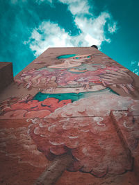 Low angle view of building against cloudy sky