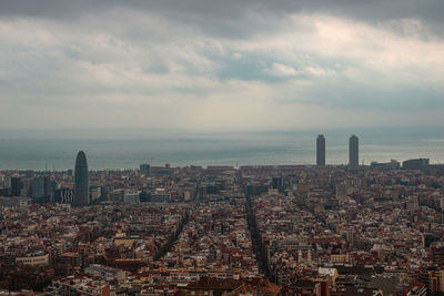 Aerial view of city by buildings against sky