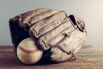 Close-up of baseball glove and ball on table