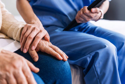 Midsection of doctor examining patient in hospital