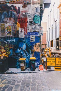 Graffiti on street amidst buildings in city