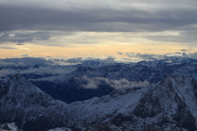 Scenic view of snowcapped mountains against sky during sunset