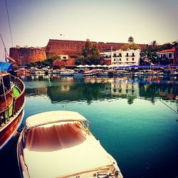 Boats in river with buildings in background