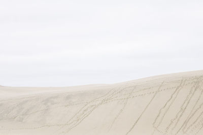 Scenic view of sandy beach against sky