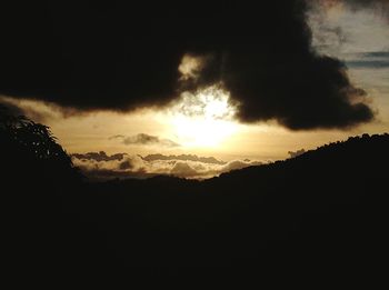 Scenic view of silhouette mountains against sky at sunset