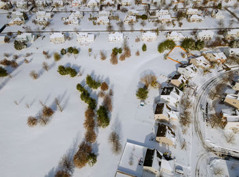 High angle view of trees by building during winter