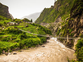 Scenic view of river flowing through mountain