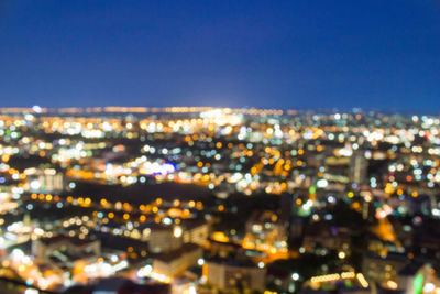 High angle view of illuminated buildings against clear sky at night