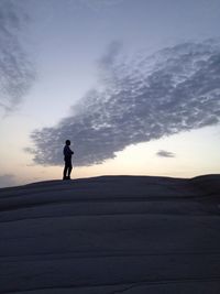 Silhouette of woman standing on landscape