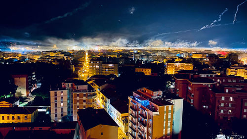 High angle view of illuminated buildings in city at night