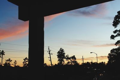 Silhouette trees against sky during sunset