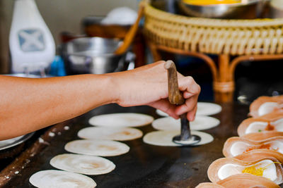 Midsection of preparing food in kitchen