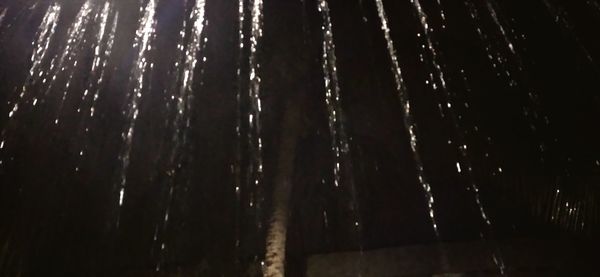 Full frame shot of wet spider web at night