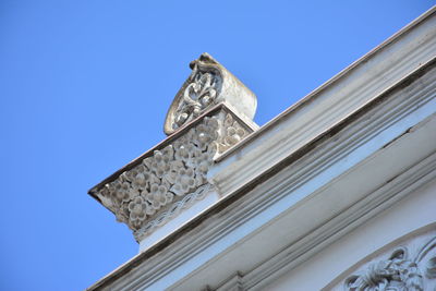 Low angle view of built structure against clear blue sky