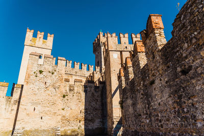 Low angle view of historical building against blue sky