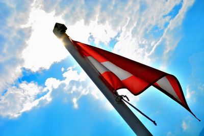 Low angle view of flag against blue sky