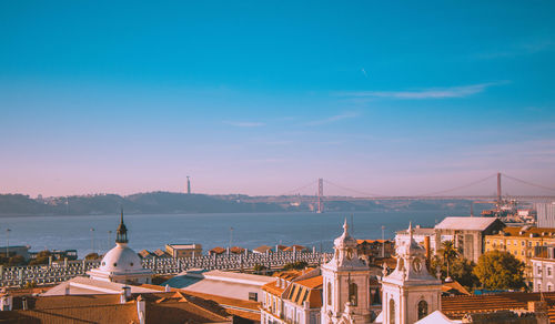 Buildings in city against blue sky