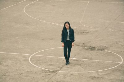 High angle portrait of young woman standing in court