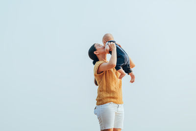 Man with woman standing against white background