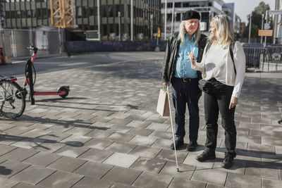 Senior couple standing in street