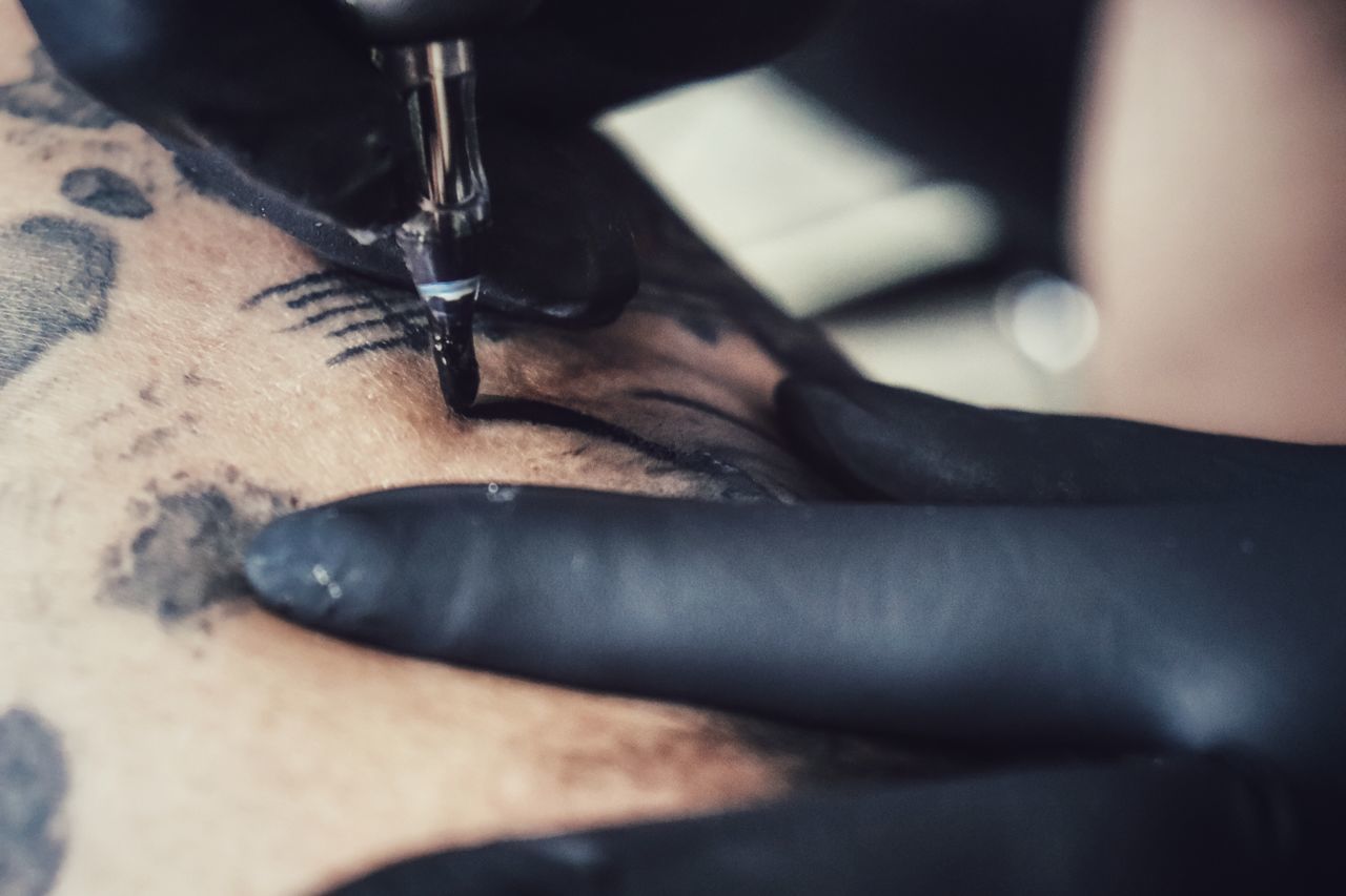 CLOSE-UP OF HANDS WORKING IN MACHINE