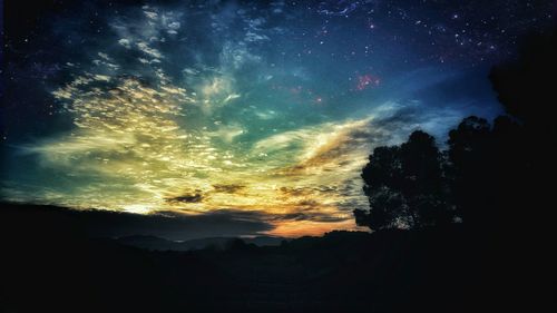 Silhouette landscape against sky at sunset