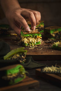 Midsection of person preparing food on cutting board