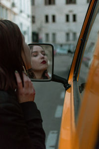 Portrait of woman seen through car window