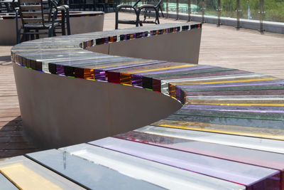 High angle view of empty glass deck chairs