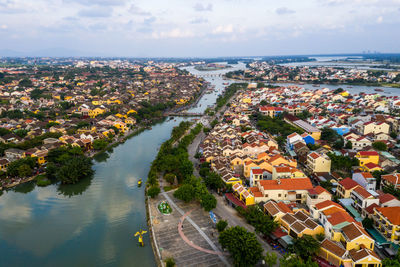 High angle view of townscape by sea against sky