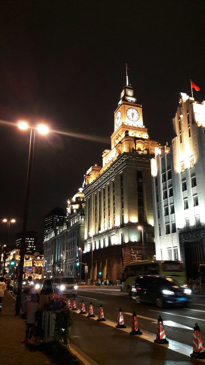 building exterior, architecture, illuminated, built structure, night, city, street, transportation, car, city life, street light, land vehicle, city street, sky, mode of transport, road, traffic, travel destinations, travel, incidental people