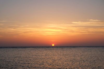 Scenic view of sea against romantic sky at sunset