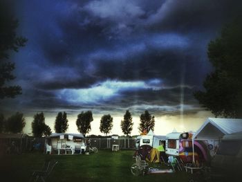 View of trees against cloudy sky