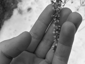 Close-up of hand holding chain