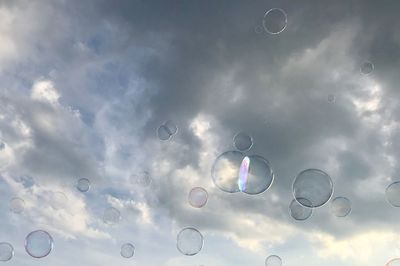 Low angle view of bubbles against sky