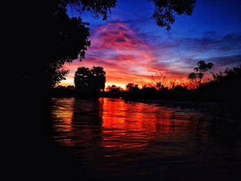 Scenic view of lake against romantic sky at sunset