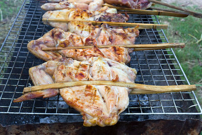 High angle view of meat on barbecue grill