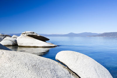 Scenic view of rocks against clear blue sky