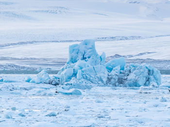 Scenic view of frozen sea against sky during winter