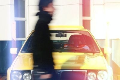 Blurred motion of man walking in car